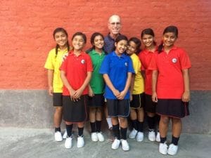 Founders Desk Bruce Keenan with Nepal Children